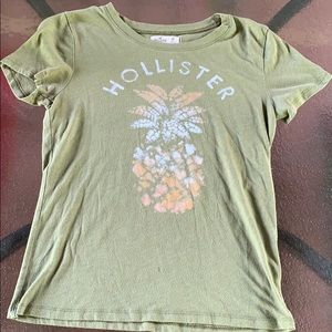 green hollister shirt with a pineapple on it.